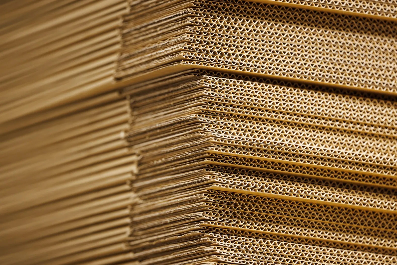 Stacks of flat corrugated shipping boxes waiting to be assembled for outgoing orders